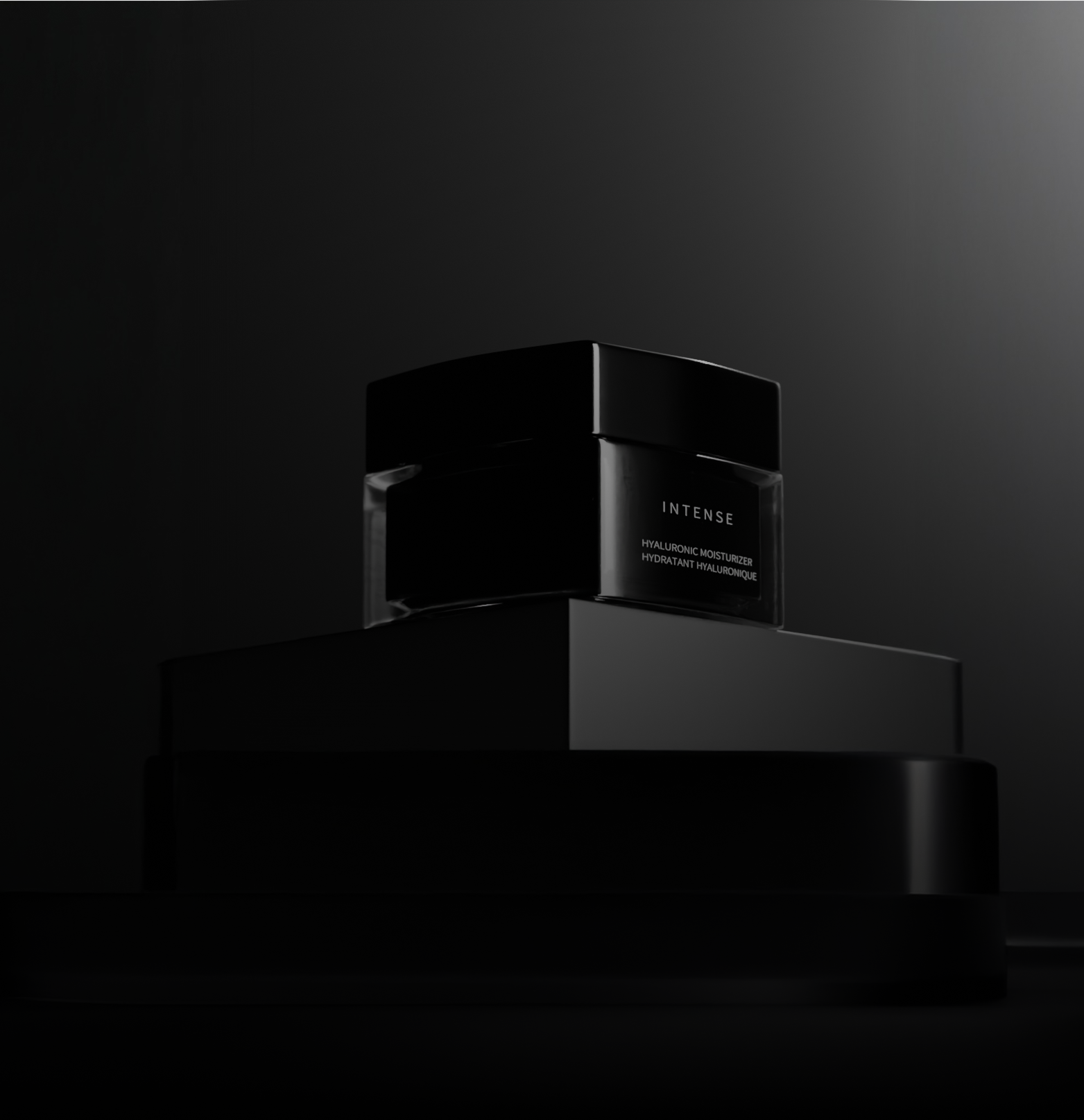 Luxurious black jar of PEXORA Intense Hyaluronic Moisturizer with sleek reflective lid on a minimal grey background.