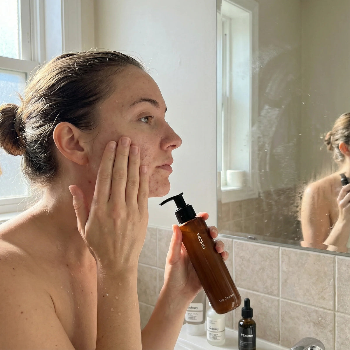 Woman applying skincare product in front of a mirror